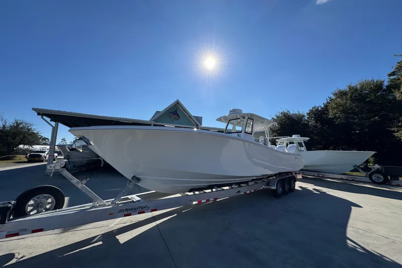 Slide: The Image of 2026 Yellowfin 36 Offshore boat on trailer under bright sunlit sky. - 4