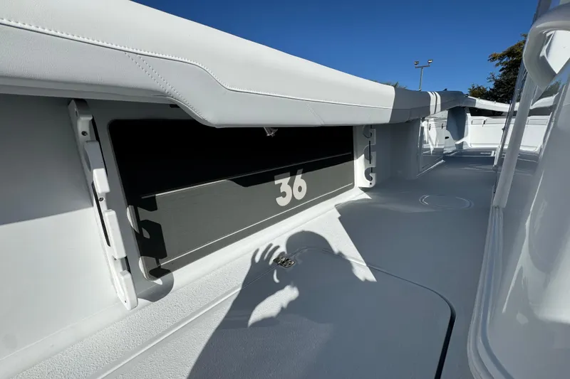 Slide: The Image of 2026 Yellowfin 36 Offshore boat interior with sleek white design and shadow play. - 44