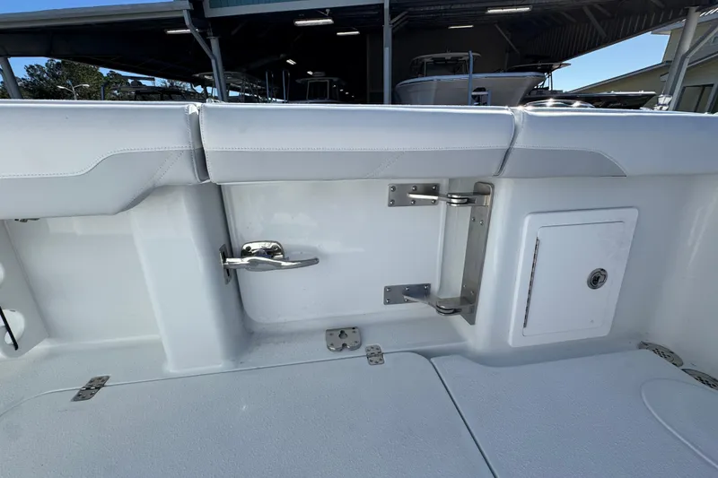Slide: The Image of 2026 Yellowfin 36 Offshore boat interior with white seating and storage compartment. - 46
