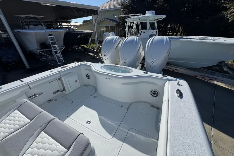 Slide: The Image of 2026 Yellowfin 36 Offshore boat with triple engines, docked in a marina. - 47