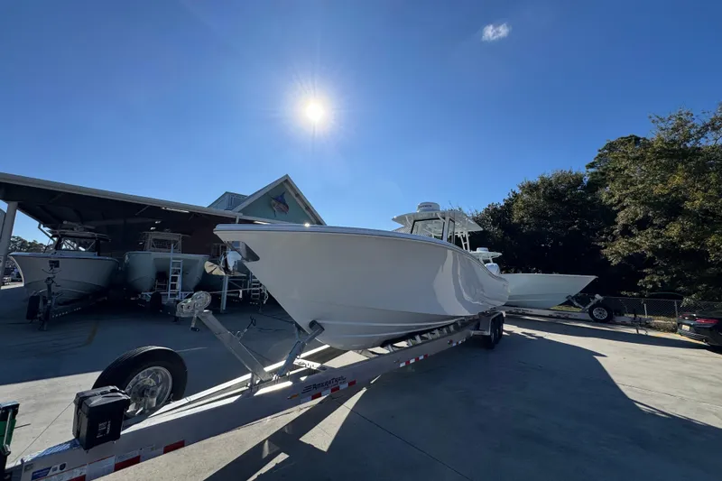 Slide: The Image of 2026 Yellowfin 36 Offshore boat on trailer under bright sunlit sky. - 5