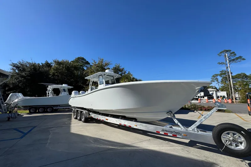 Slide: The Image of 2026 Yellowfin 36 Offshore boat on trailer under clear blue sky. - 9