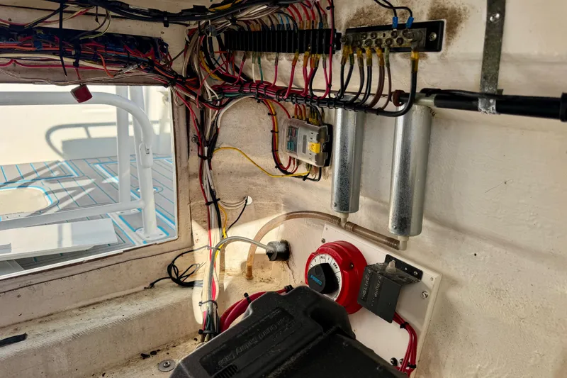 Slide: The Image of Electrical wiring and components inside a 2000 Contender 23 Open boat. - 13