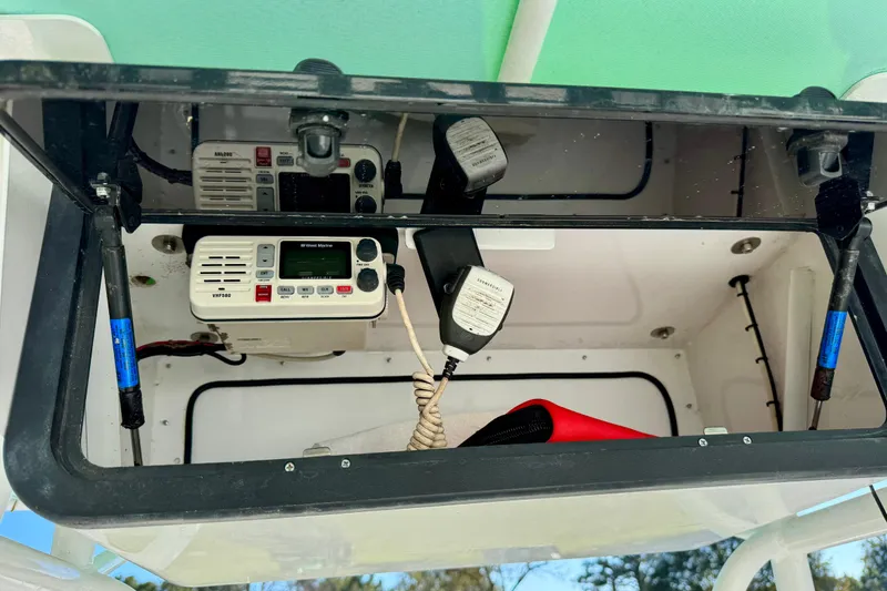 Slide: The Image of 2000 Contender 23 Open boat console with radio equipment and storage compartment. - 15