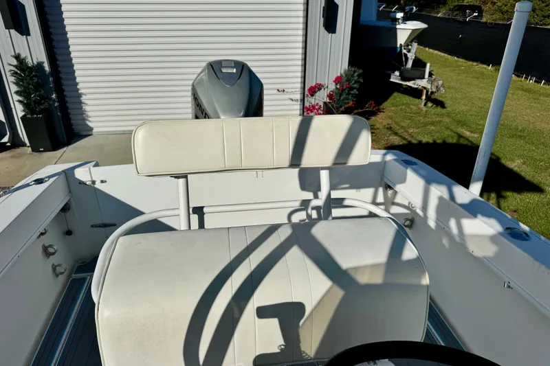 Slide: The Image of 2000 Contender 23 Open boat interior with white seating and Honda outboard motor. - 16