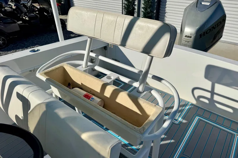 Slide: The Image of 2000 Contender 23 Open boat interior with seating and storage compartment. - 17