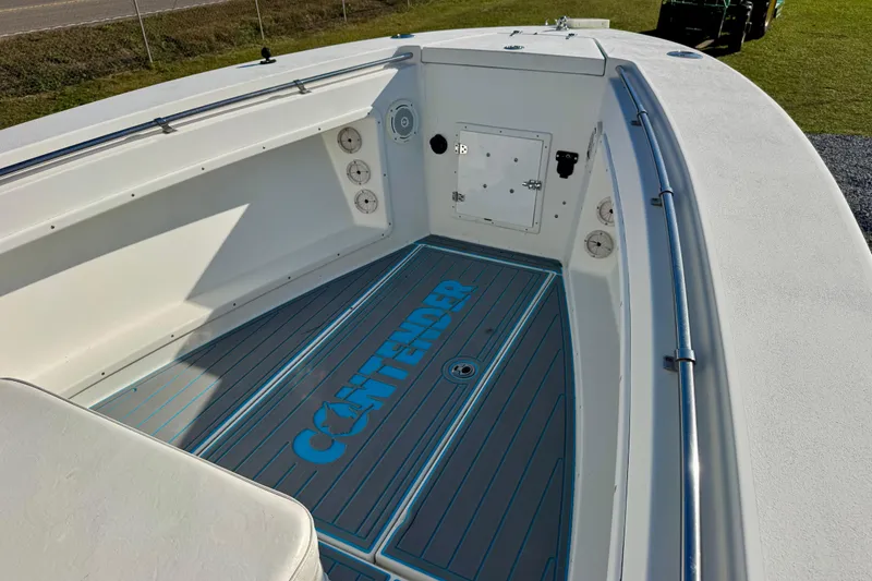 Slide: The Image of 2000 Contender 23 Open boat interior with branded flooring and storage compartments. - 6