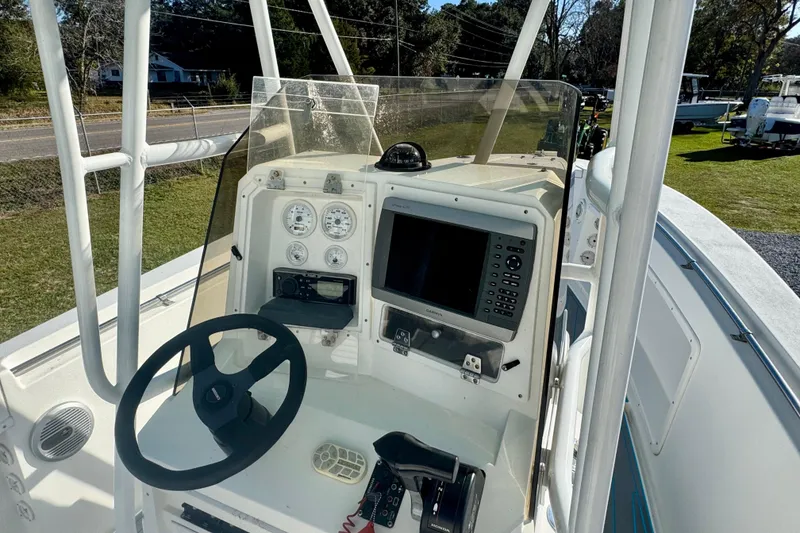 Slide: The Image of 2000 Contender 23 Open boat dashboard with steering wheel and navigation equipment. - 9