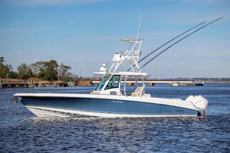 The Image of 2019 Boston Whaler 350 Outrage boat on calm water, clear sky background. - 1