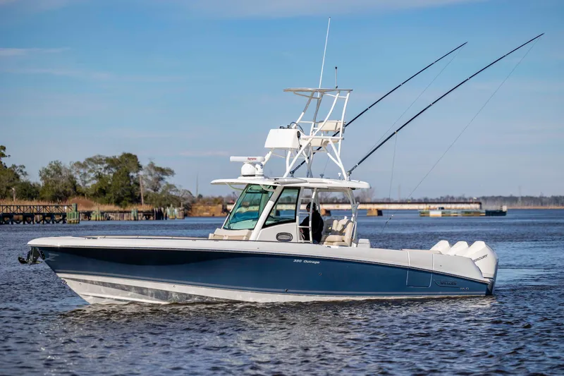 Slide: The Image of 2019 Boston Whaler 350 Outrage boat cruising on a calm river. - 10