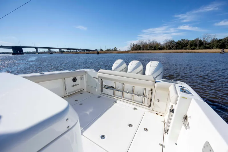 Slide: The Image of 2019 Boston Whaler 350 Outrage boat with triple Mercury engines on a sunny day. - 12