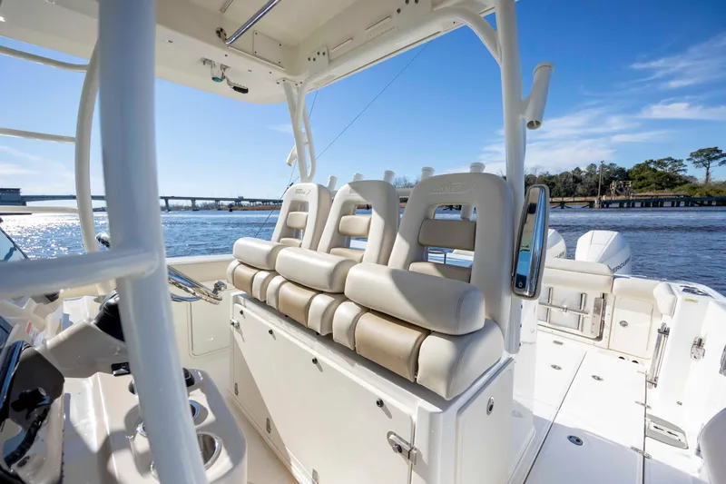 Slide: The Image of 2019 Boston Whaler 350 Outrage boat interior with luxurious seating and scenic water view. - 22