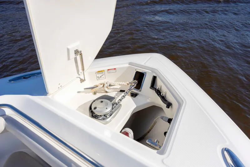 Slide: The Image of 2019 Boston Whaler 350 Outrage anchor compartment with rope and chain on water. - 26
