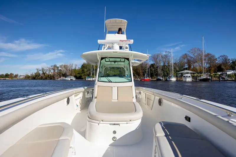 Slide: The Image of 2019 Boston Whaler 350 Outrage boat on calm water, clear sky, and scenic background. - 27
