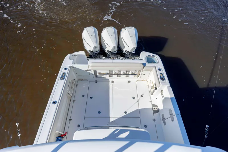 Slide: The Image of 2019 Boston Whaler 350 Outrage boat with triple outboard engines on water. - 33