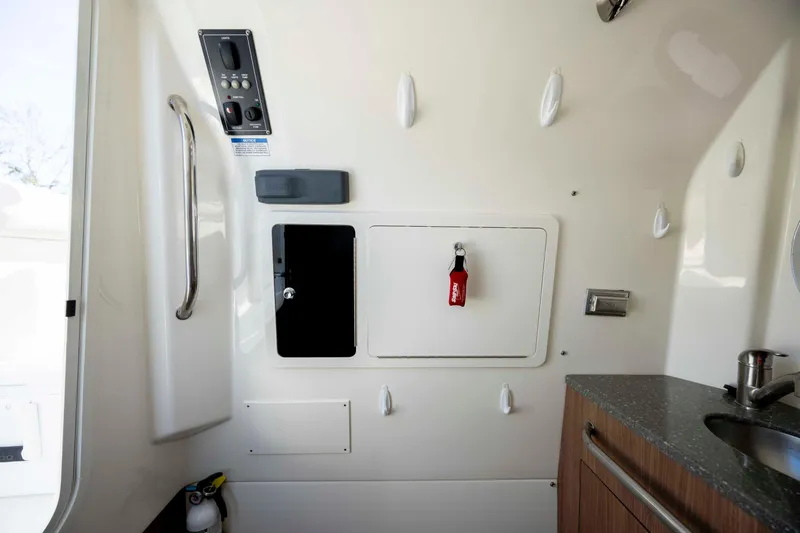 Slide: The Image of Interior of 2019 Boston Whaler 350 Outrage boat, featuring control panel and storage. - 37