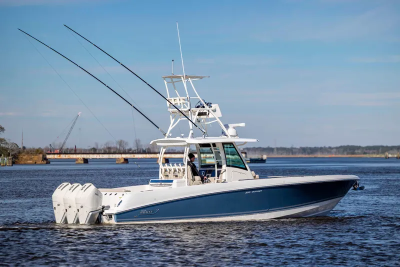 Slide: The Image of 2019 Boston Whaler 350 Outrage boat cruising on a calm river. - 5