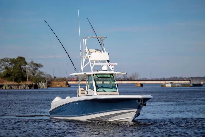 Slide: The Image of 2019 Boston Whaler 350 Outrage boat cruising on calm waters. - 8