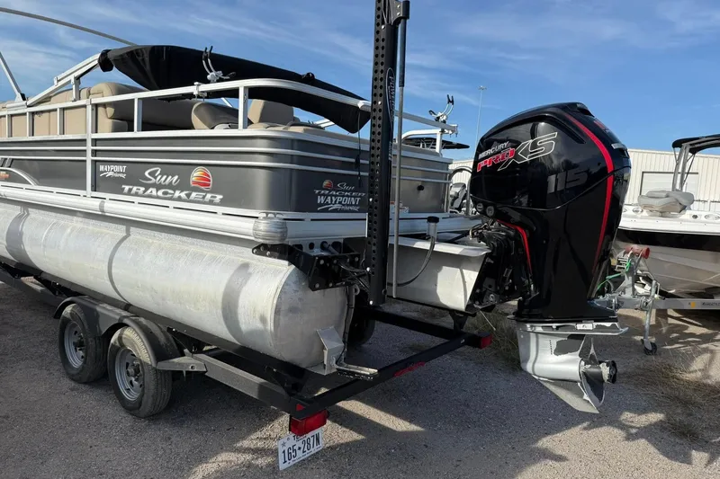 The Image of 2023 Sun Tracker Fishin' Barge 22 DLX with Mercury Pro XS engine on trailer. - 0