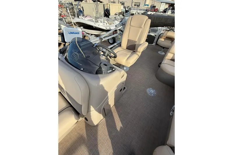 Slide: The Image of 2023 Sun Tracker Fishin' Barge 22 DLX pontoon boat with powerful outboard motor. - 2