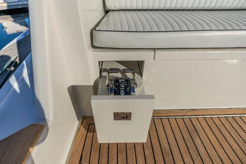 Slide: The Image of Control panel on 1993 Ocean 65 Custom yacht with teak flooring and cushioned seating. - 10