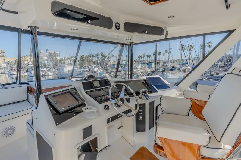 Slide: The Image of Luxurious 1993 Ocean 65 Custom yacht cockpit with marina view and modern navigation equipment. - 12