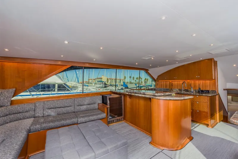 Slide: The Image of Luxurious interior of 1993 Ocean 65 Custom yacht with elegant wood finishes and marina view. - 20