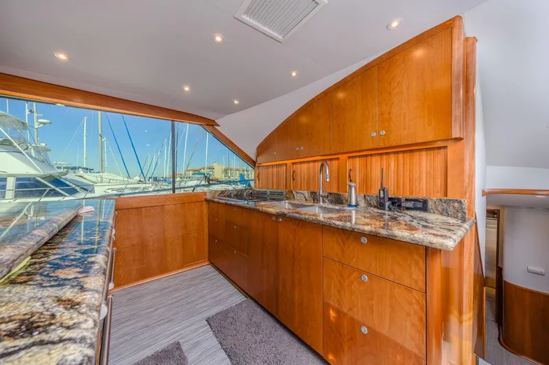 Slide: The Image of Luxurious 1993 Ocean 65 Custom yacht kitchen with granite countertops and wooden cabinetry. - 23