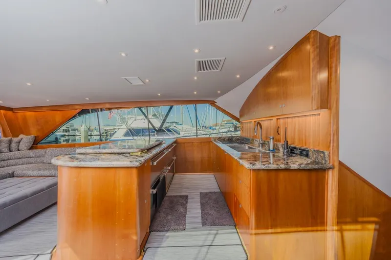 Slide: The Image of Luxurious interior of 1993 Ocean 65 Custom yacht with modern kitchen and seating area. - 24