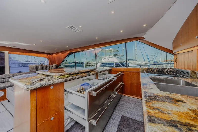 Slide: The Image of Luxurious interior of 1993 Ocean 65 Custom yacht with granite countertops and marina view. - 25