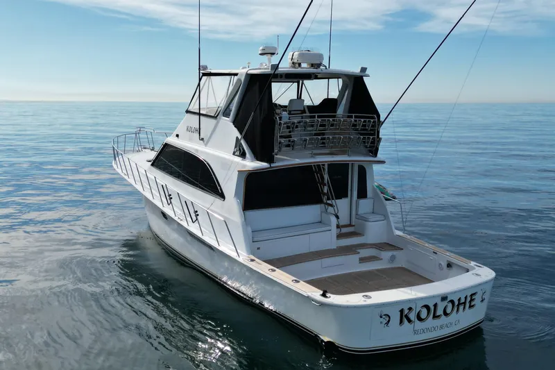 Slide: The Image of 1993 Ocean 65 Custom yacht on calm sea, featuring spacious deck and sleek design. - 3