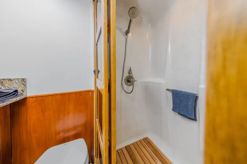 Slide: The Image of Bathroom interior of 1993 Ocean 65 Custom yacht with shower and wooden accents. - 33