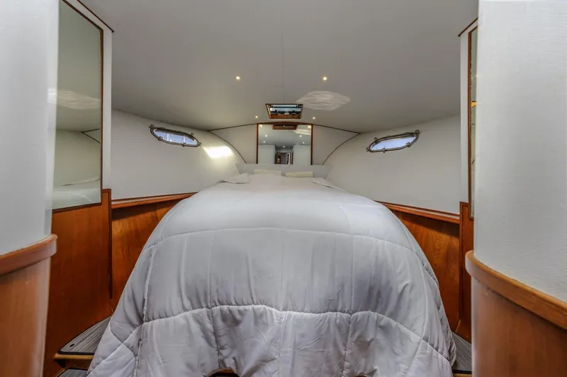 Slide: The Image of Luxurious bedroom interior of 1993 Ocean 65 Custom yacht with elegant wood accents. - 34