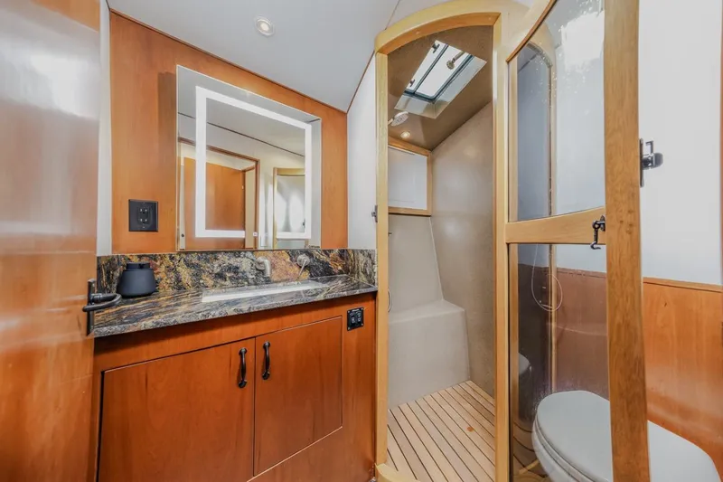 Slide: The Image of Luxurious bathroom in 1993 Ocean 65 Custom yacht with wood accents and modern fixtures. - 35
