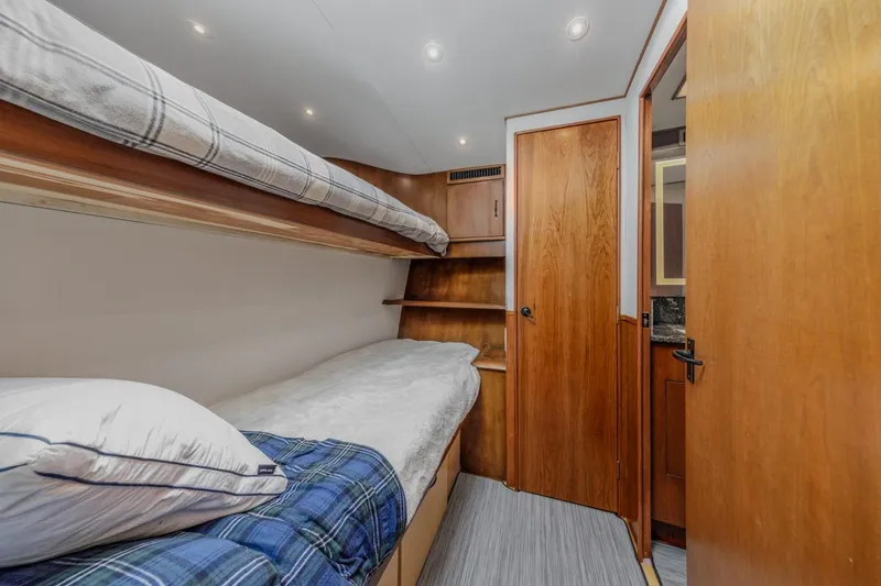 Slide: The Image of Cozy cabin interior of 1993 Ocean 65 Custom yacht with bunk beds and wooden finishes. - 37