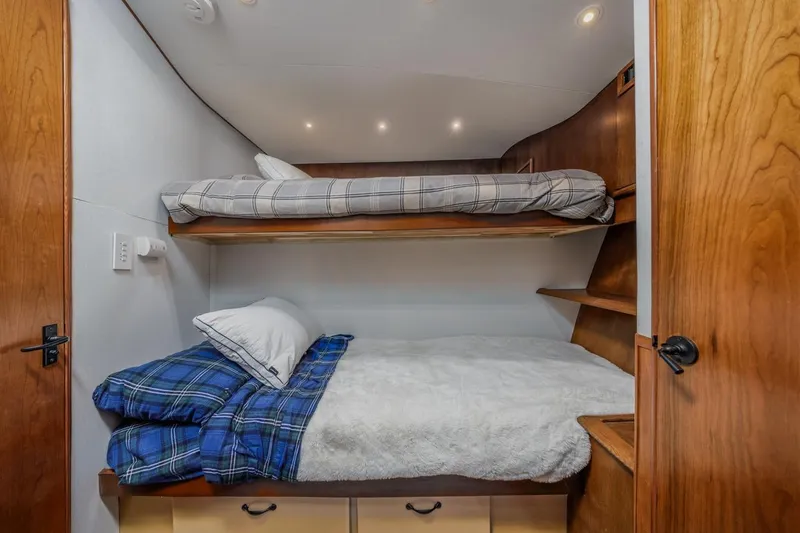 Slide: The Image of Cozy bunk beds in 1993 Ocean 65 Custom yacht cabin with wooden accents. - 38
