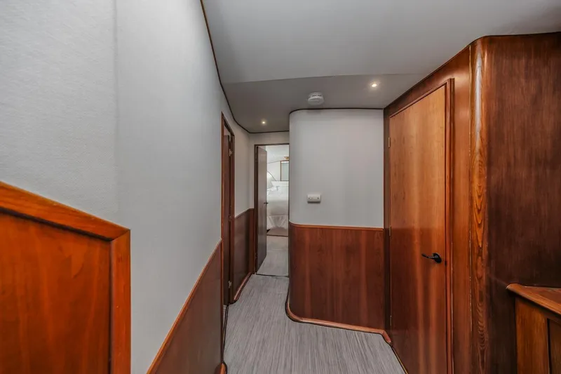 Slide: The Image of Hallway of 1993 Ocean 65 Custom yacht with wooden paneling and modern design. - 39