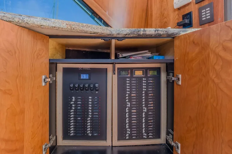 Slide: The Image of Electrical panel inside 1993 Ocean 65 Custom yacht with wooden cabinetry. - 41