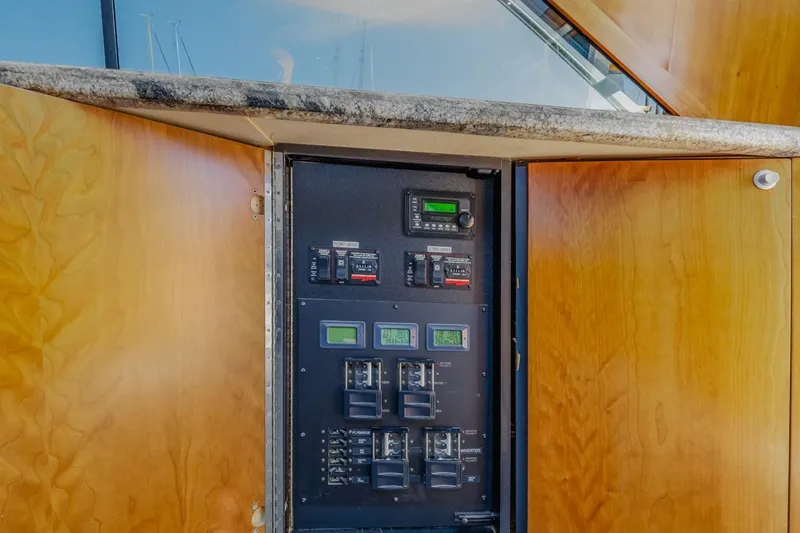 Slide: The Image of Electrical panel inside 1993 Ocean 65 Custom yacht with wooden cabinetry. - 42