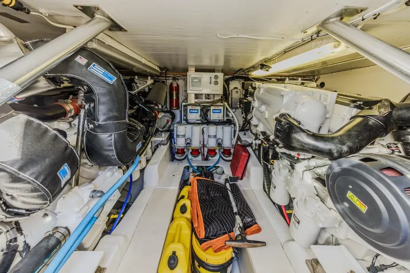 Slide: The Image of Engine room of 1993 Ocean 65 Custom yacht, featuring mechanical equipment and tools. - 44
