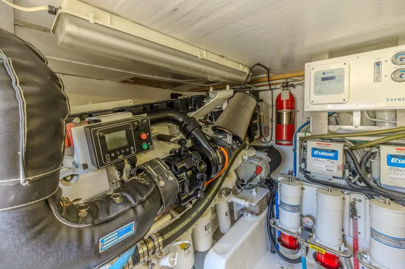 Slide: The Image of Engine room of a 1993 Ocean 65 Custom yacht, featuring mechanical components and control systems. - 46