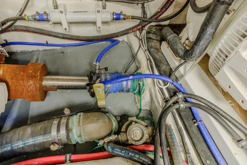 Slide: The Image of Engine room of a 1993 Ocean 65 Custom yacht, featuring complex machinery and equipment. - 49