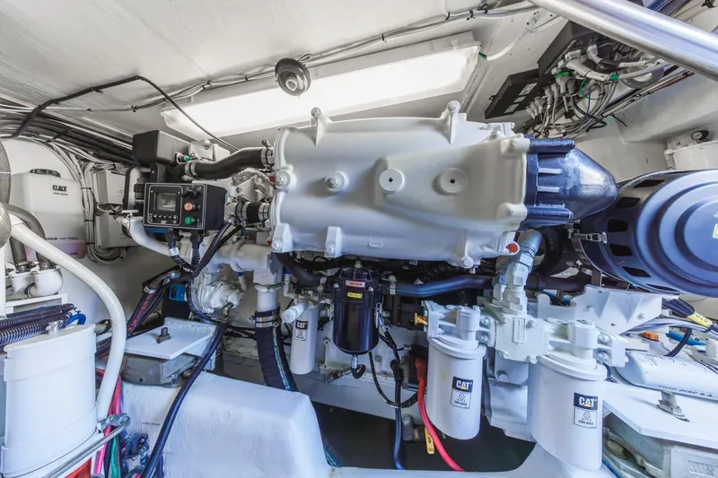 Slide: The Image of Engine room of a 1993 Ocean 65 Custom yacht, featuring CAT machinery and components. - 52