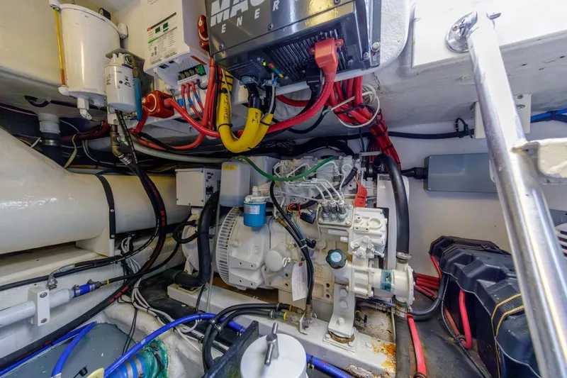 Slide: The Image of Engine room of a 1993 Ocean 65 Custom yacht, showcasing complex wiring and machinery. - 55