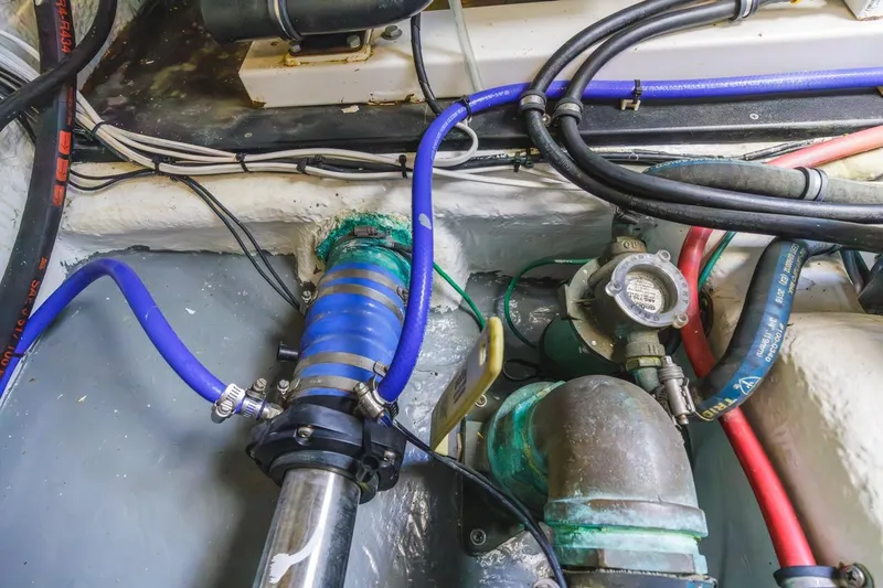 Slide: The Image of Engine compartment of a 1993 Ocean 65 Custom boat with hoses and mechanical components. - 56