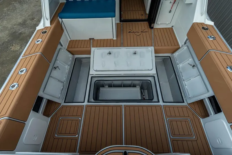 Slide: The Image of 2025 Makaira Gen 3 36 boat interior with storage compartments and teak flooring. - 13