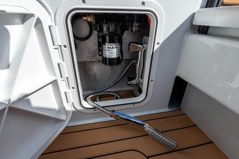 Slide: The Image of Makaira Gen 3 36 (2025) boat compartment with MaxFlo pressure pump and shower head. - 19