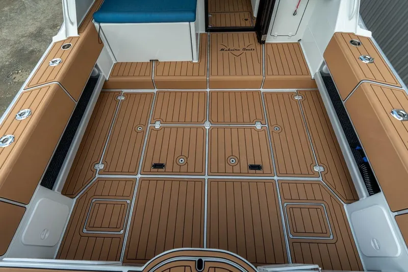 Slide: The Image of Makaira Gen 3 36 boat deck, 2025 model, featuring tan and white cushioned seating. - 2