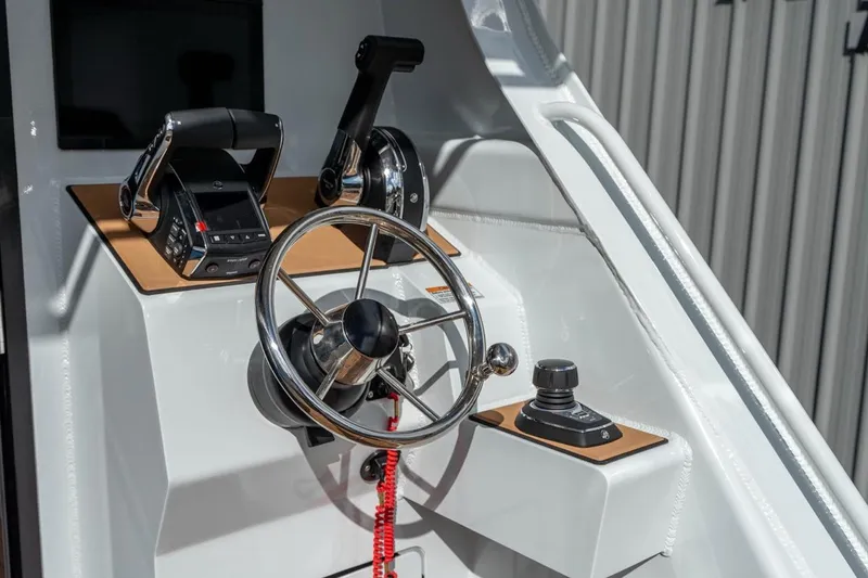 Slide: The Image of Steering console of 2025 Makaira Gen 3 36 boat with modern controls and wheel. - 4