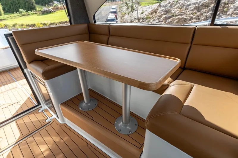 Slide: The Image of Luxurious interior of 2025 Makaira Gen 3 36 yacht with brown seating and wooden table. - 6